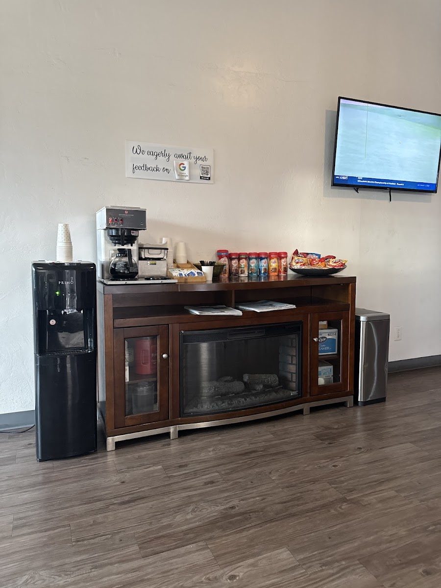 The free coffee and snack station with a water dispenser